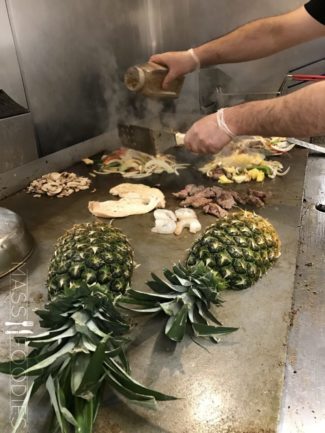 In the kitchen at Plaza Azteca Worcester, preparing the Pina Loca (Grilled Pineapple stuffed with Chicken, Steak, Peppers and Onions in a "al pastor sauce" topped with melted Cheese with a side of white Rice) being cooked.