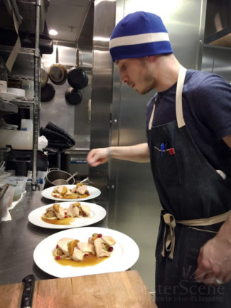 Executive Chef Damien Evangelous prepares dishes at Armsby Abbey with locally sourced, sustainable ingredients.