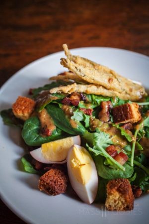 Chef's Best Spinach and Baby Kale Salad (Cob Bacon Lardon, red onion, pickled egg, cornbread crouton, roasted green tomato vinaigrette)
