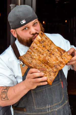Chef Michael Arrastia paying his respect to the bacon at Hangover Pub on Green Street in Worcester, MA (Photograph by Alex Belisle)