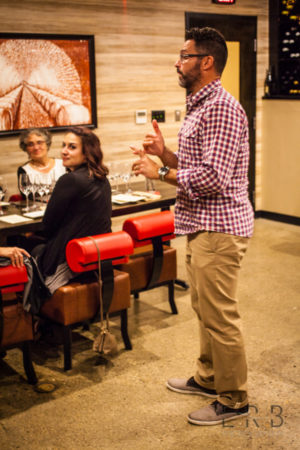 Michael Covino, president of Niche Hospitality Group, talking to attendees about each wine pairing during Chef's Best: The Champagne Experience at Bocado in Wellesley, MA
