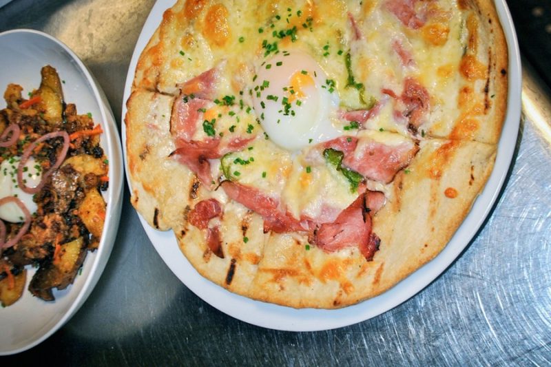 Breakfast Pizza – Sliced Applewood smoked ham, chopped jalapeños, Vermont cheddar, a soft-cooked egg, beer béchamel sauce.